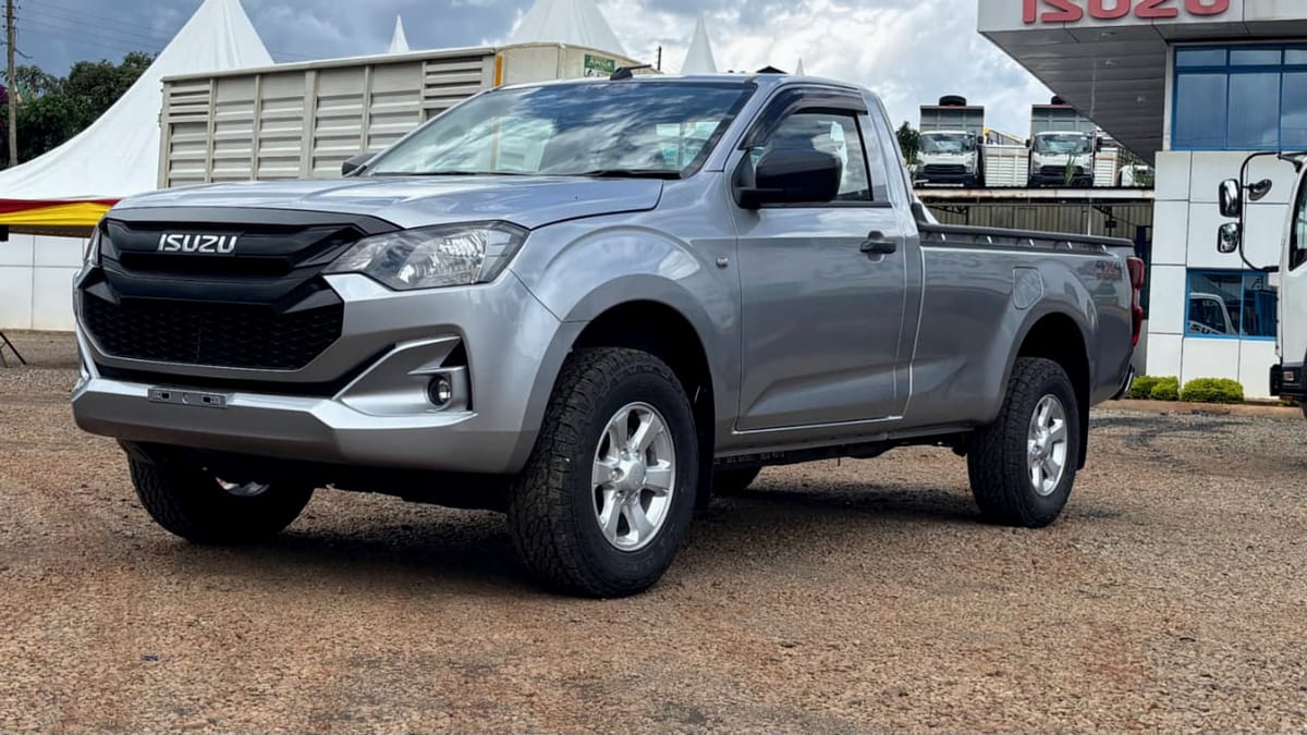 Isuzu D-Max Single Cab in silver, front three-quarter view on an Isuzu dealership forecourt, with the full-length load box behind the two-seat cab.