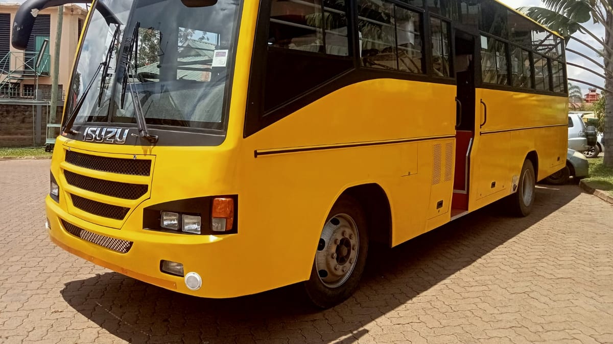 Isuzu FTR90P Bus, 51 seats in yellow school livery, front three-quarter view, with the passenger door open ahead of the front axle.