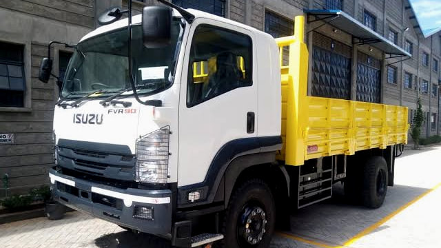 Isuzu FVR90 in white with a yellow dropside body, front three-quarter view, with the FVR90 badge on the cab door.