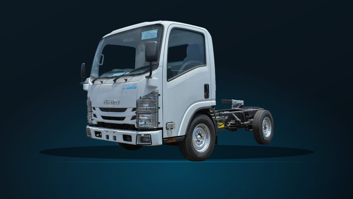 Isuzu NLR77E cab chassis, front three-quarter view on a dark studio ground, showing the single rear wheels that distinguish it from the rest of the N-Series.