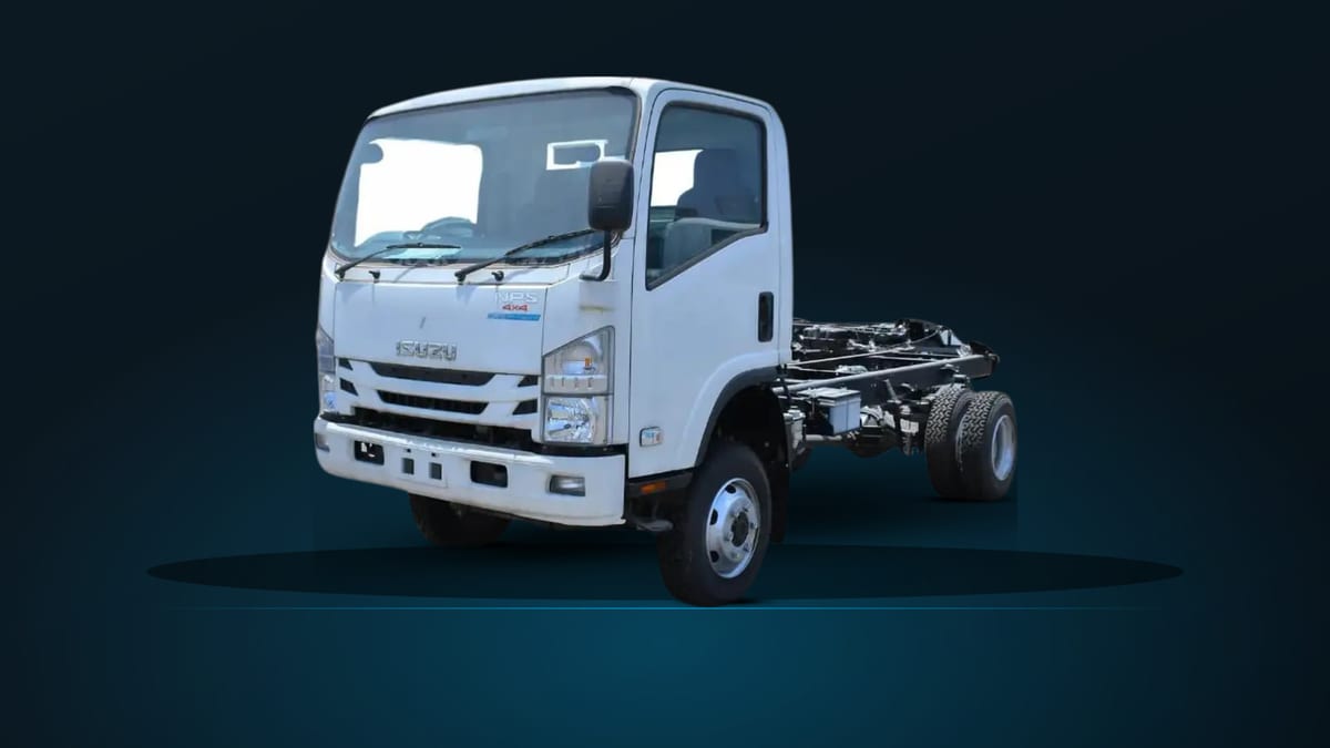 Isuzu NPS81H 4x4 cab chassis, front three-quarter view on a dark studio ground, showing the bare frame rails and the raised four-wheel-drive stance.